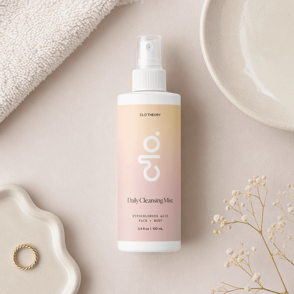 Clo Daily Cleansing Mist lying flat among a towel, ceramics, and baby's breath